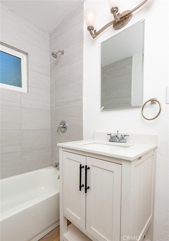 bathroom featuring vanity and tiled shower / bath combo