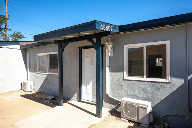 view of exterior entry featuring ac unit