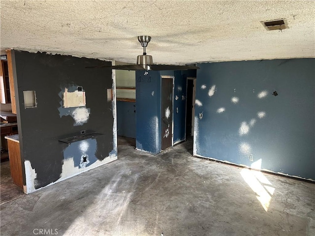 interior space featuring a textured ceiling