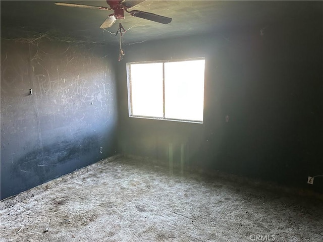 empty room with ceiling fan and carpet floors