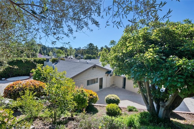 view of side of property with a patio area