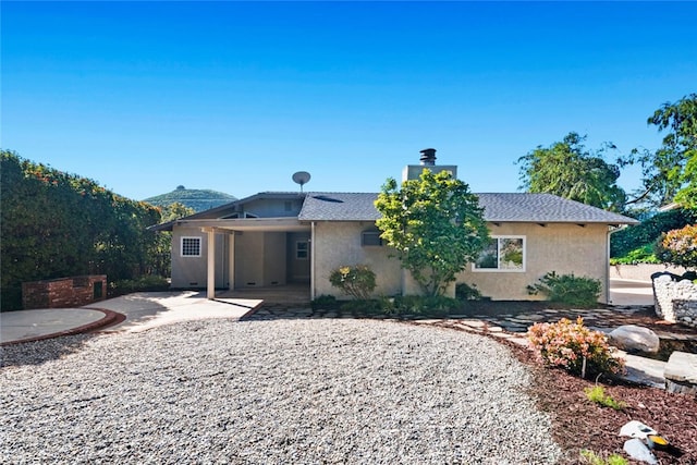 view of front of house featuring a mountain view and a patio area