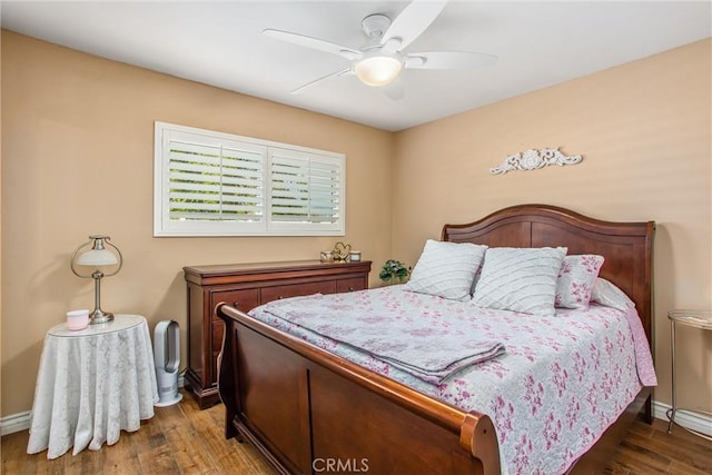 bedroom with ceiling fan and dark hardwood / wood-style floors