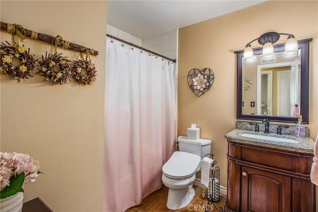 bathroom with toilet, a shower with curtain, wood-type flooring, and vanity