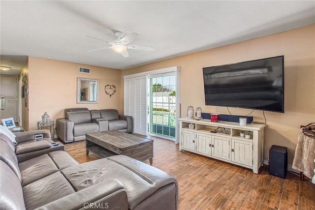 living room featuring ceiling fan and light hardwood / wood-style floors