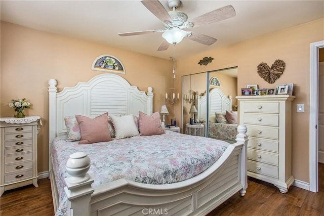 bedroom with ceiling fan, a closet, and dark hardwood / wood-style flooring