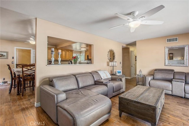 living room with ceiling fan and hardwood / wood-style flooring