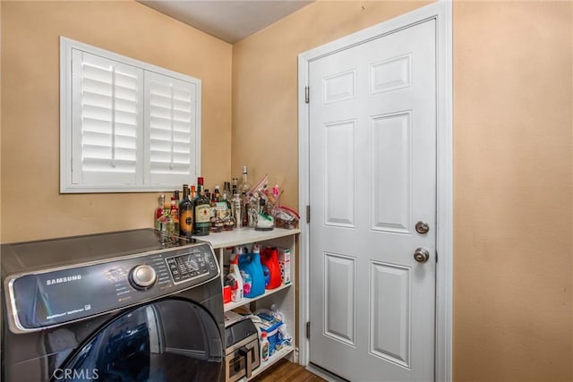 washroom with wood-type flooring and washer / clothes dryer