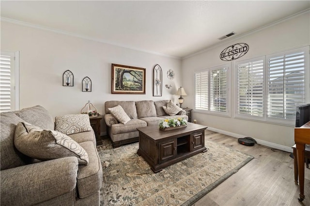 living room featuring crown molding and light wood-type flooring