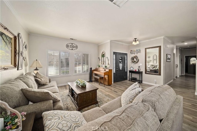 living room with crown molding and light hardwood / wood-style flooring