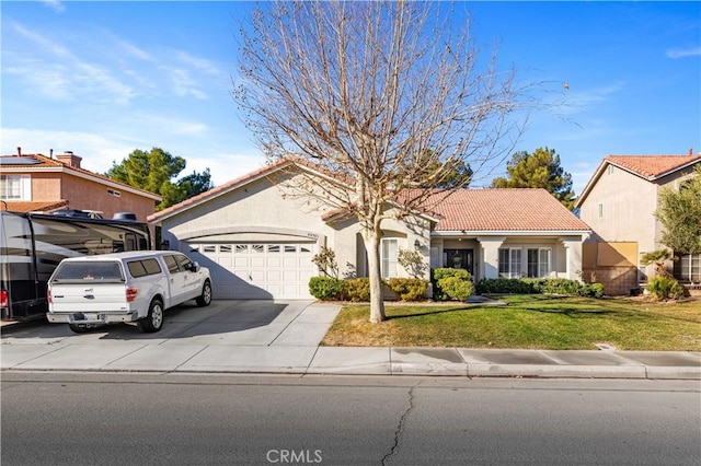 view of front of property with a front yard and a garage