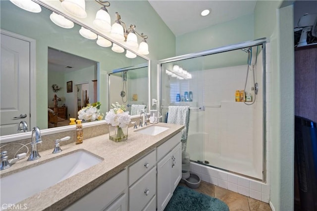 bathroom with tile patterned flooring, vanity, and a shower with door