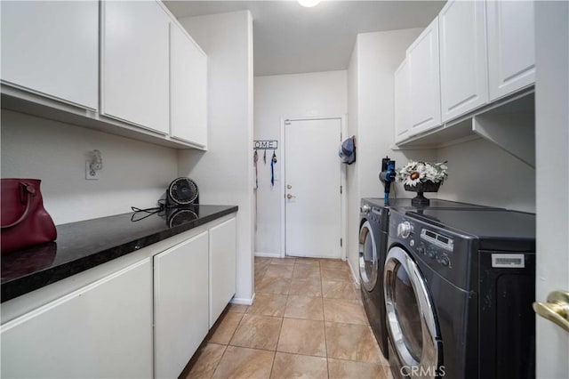 washroom featuring cabinets, independent washer and dryer, and light tile patterned floors