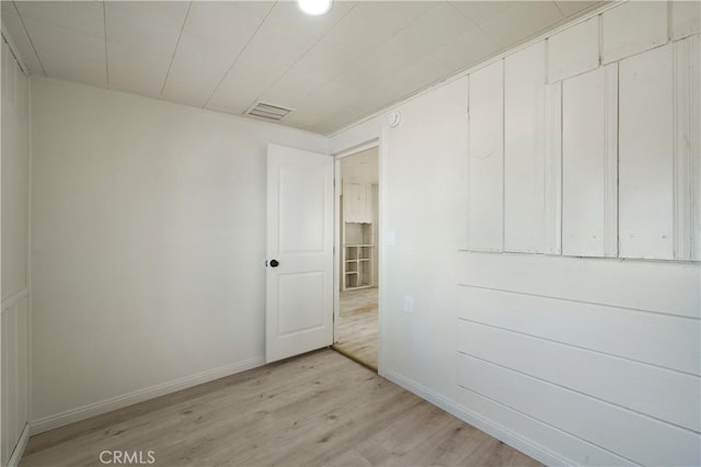 unfurnished room with light hardwood / wood-style flooring