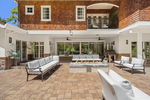 exterior space with an outdoor kitchen, ceiling fan, an outdoor hangout area, and a balcony