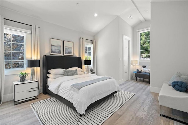 bedroom featuring lofted ceiling and light wood-type flooring