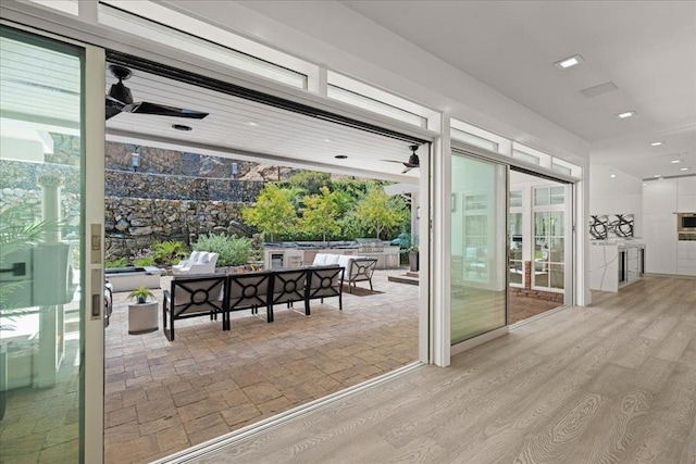 entryway featuring light wood-type flooring and ceiling fan