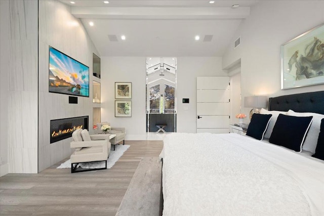 bedroom with access to exterior, light hardwood / wood-style flooring, high vaulted ceiling, and beamed ceiling