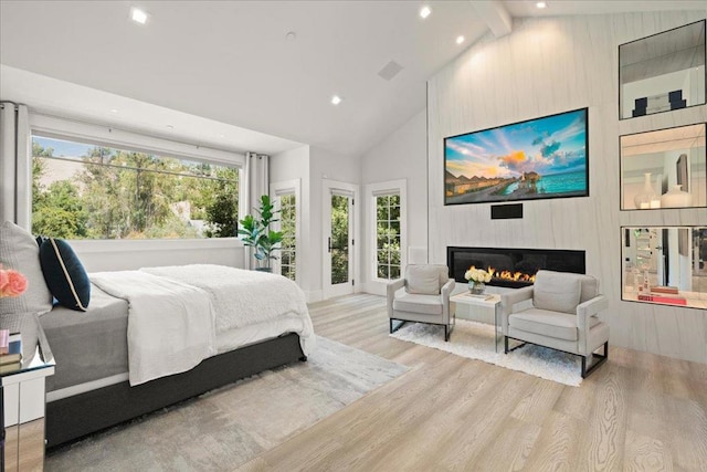 bedroom with multiple windows, light hardwood / wood-style flooring, high vaulted ceiling, and beamed ceiling