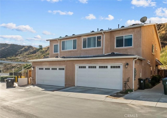 front of property featuring a garage and a mountain view