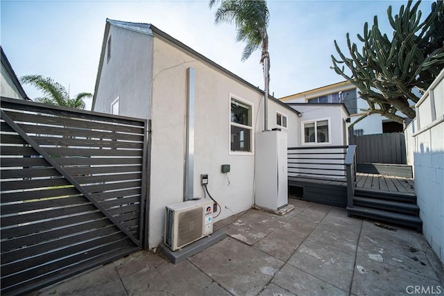 view of side of home featuring a deck and a patio