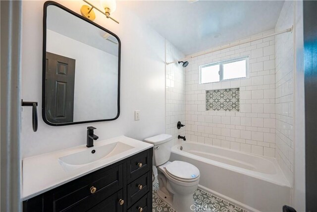 full bathroom featuring vanity, tiled shower / bath combo, and toilet