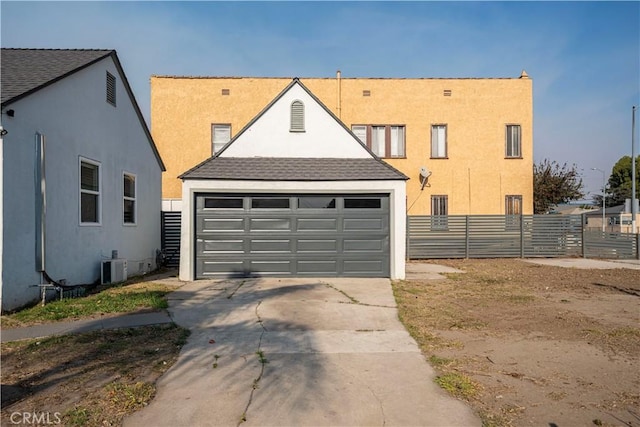 view of front of home with central AC, an outdoor structure, and a garage