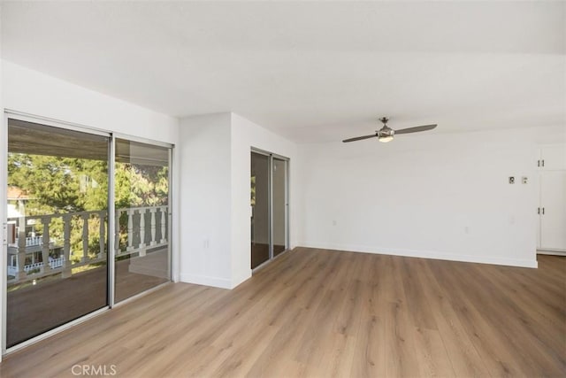 empty room with ceiling fan and light hardwood / wood-style flooring