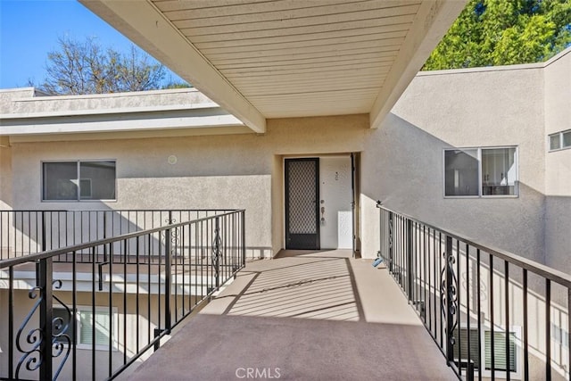 view of exterior entry with a balcony