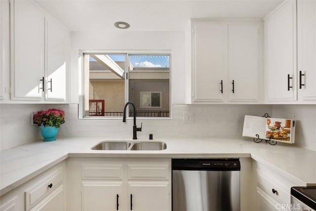 kitchen featuring dishwasher, white cabinets, and sink