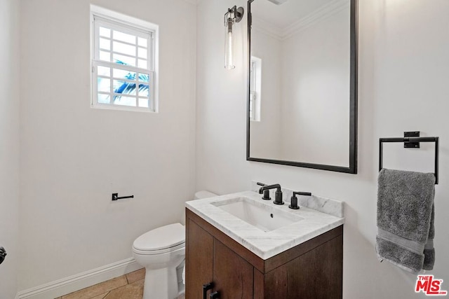 bathroom with tile patterned floors, vanity, toilet, and crown molding