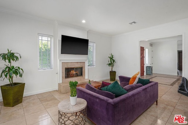 tiled living room with a tile fireplace and ornamental molding