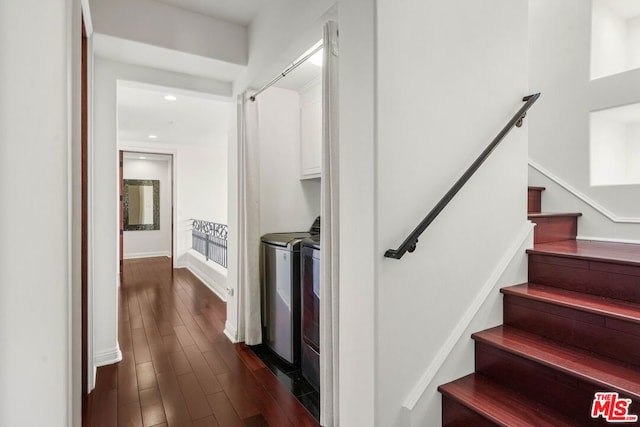 stairs featuring hardwood / wood-style flooring and independent washer and dryer