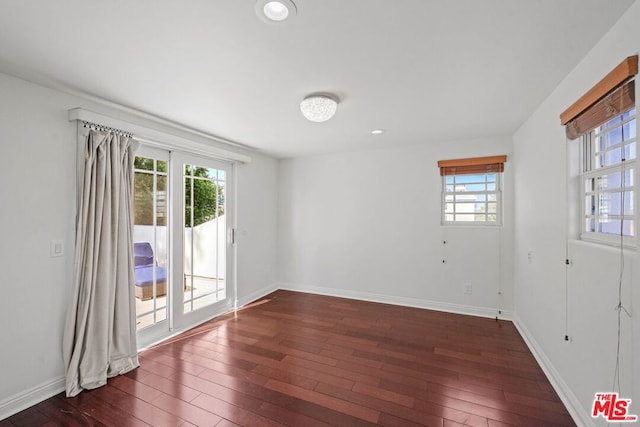 spare room with dark hardwood / wood-style floors