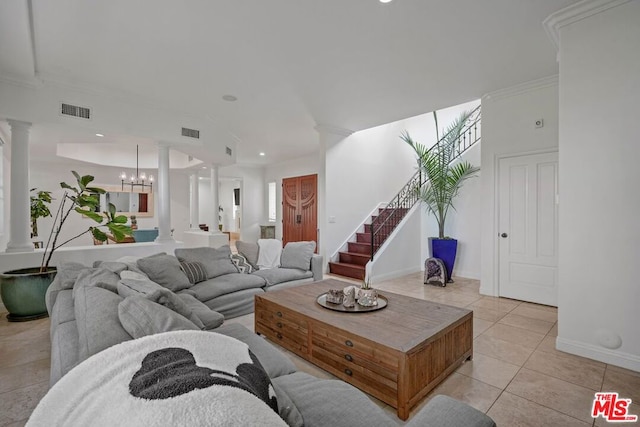 tiled living room with a chandelier and crown molding