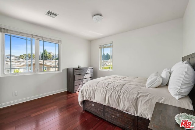 bedroom with dark hardwood / wood-style floors