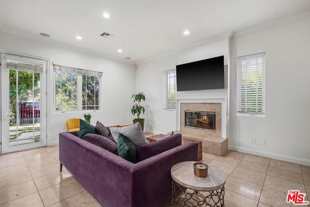 tiled living room featuring crown molding and a tiled fireplace