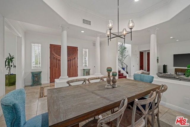 dining area featuring a tray ceiling, light tile patterned floors, ornamental molding, and a notable chandelier