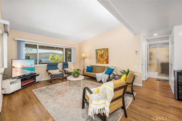 living room featuring hardwood / wood-style floors and vaulted ceiling