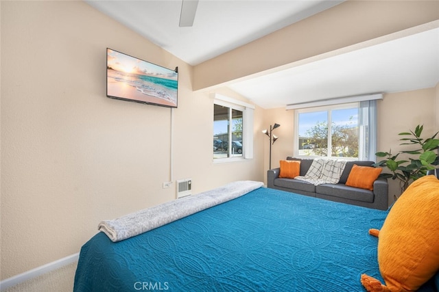 carpeted bedroom with vaulted ceiling and ceiling fan