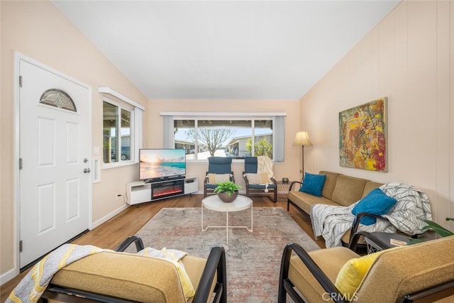 living room featuring hardwood / wood-style flooring and lofted ceiling