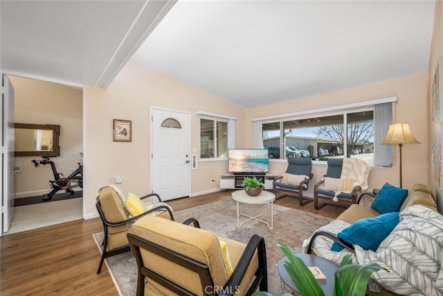 living room featuring hardwood / wood-style flooring and vaulted ceiling