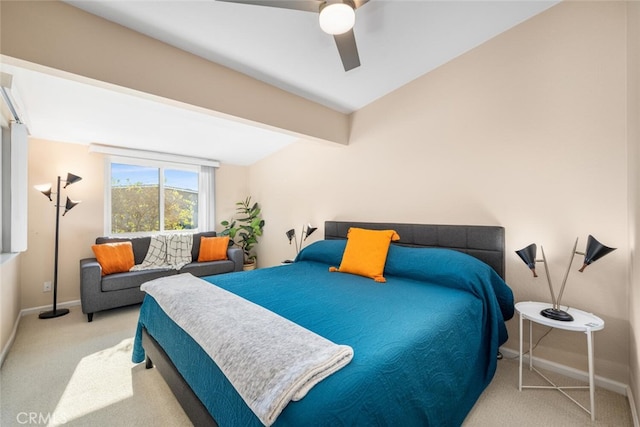 bedroom featuring light carpet, ceiling fan, and beamed ceiling