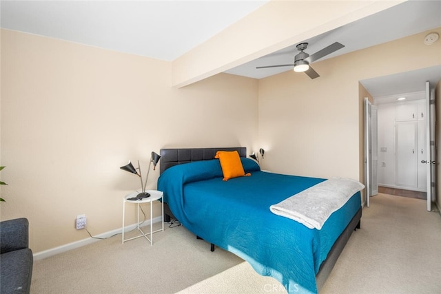 bedroom with beam ceiling, light colored carpet, and ceiling fan