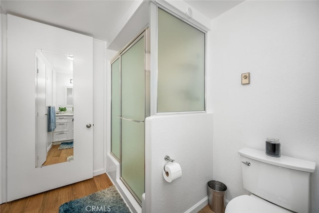 bathroom with wood-type flooring and toilet