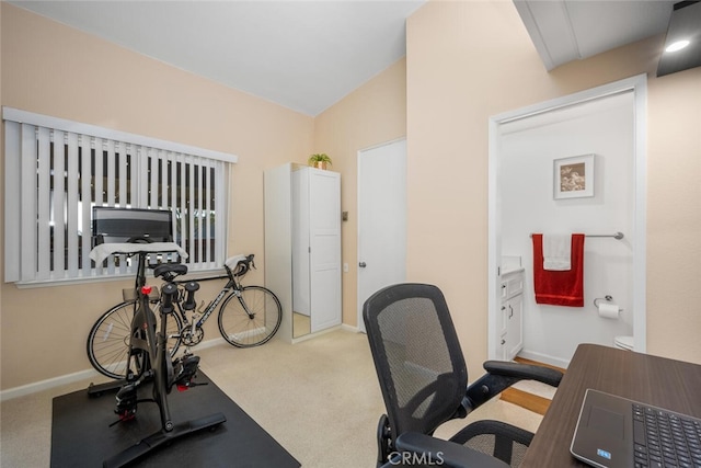 workout room featuring carpet floors and vaulted ceiling