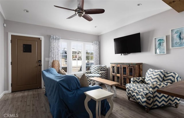 living room with dark hardwood / wood-style floors and ceiling fan