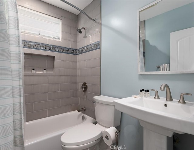 full bathroom with toilet, shower / bath combo with shower curtain, and sink