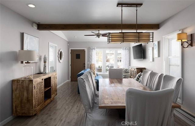 dining space with beamed ceiling, ceiling fan, and wood-type flooring