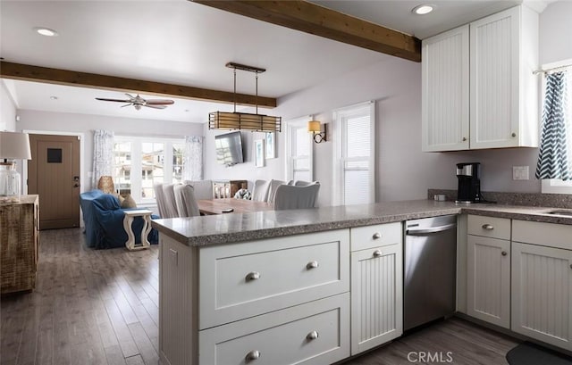 kitchen featuring kitchen peninsula, beam ceiling, and white cabinetry